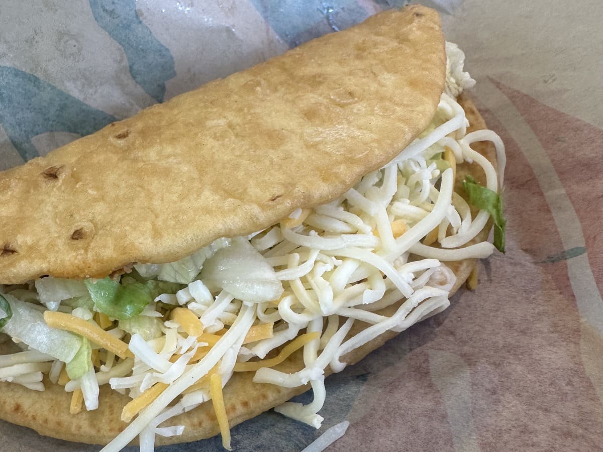 Taco Bell vegetarian menu featuring a taco with cheese, lettuce, and sour cream.