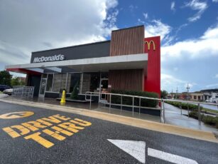 A mcdonald's restaurant with a drive thru sign.