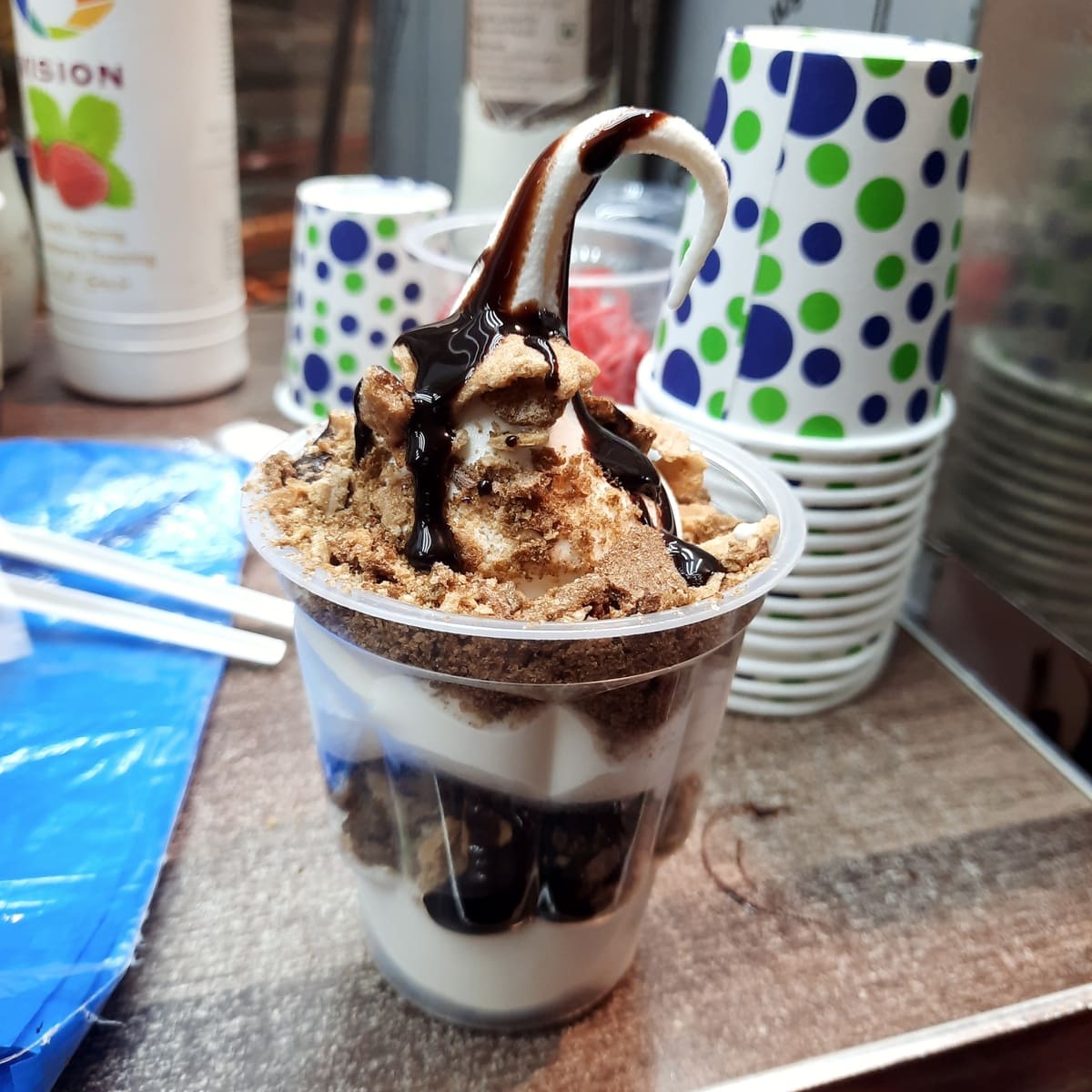 A cup of ice cream with a scoop of ice cream on top.